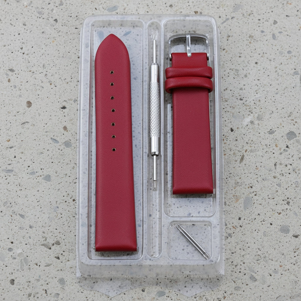 Red leather watch strap with tools in a clear plastic case 