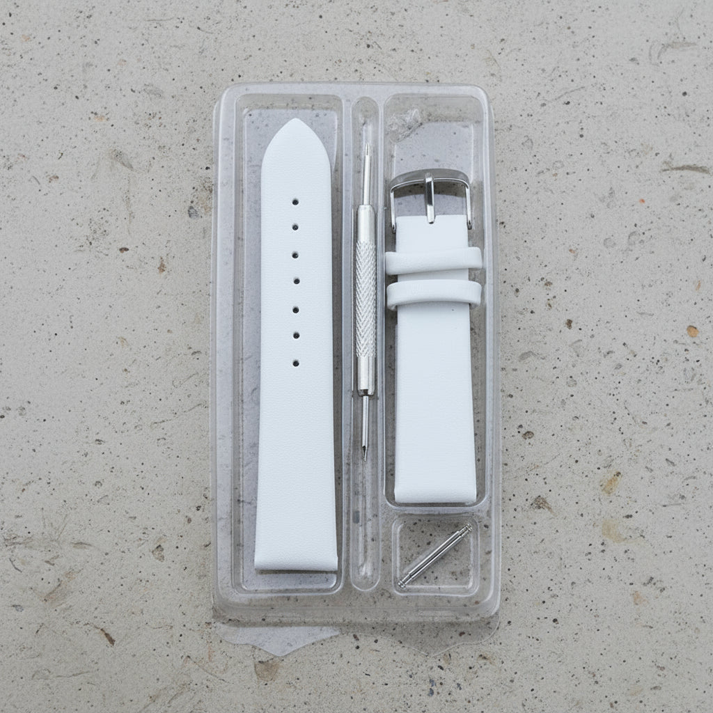 White leather watch strap set with tool in clear packaging 
