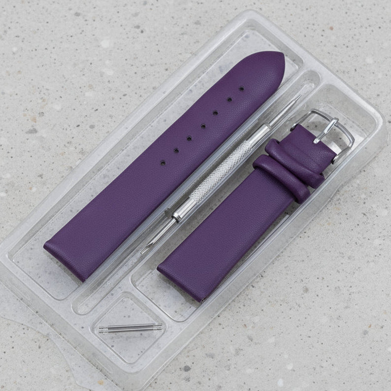 Purple leather watch strap with silver tools in a clear plastic packaging 