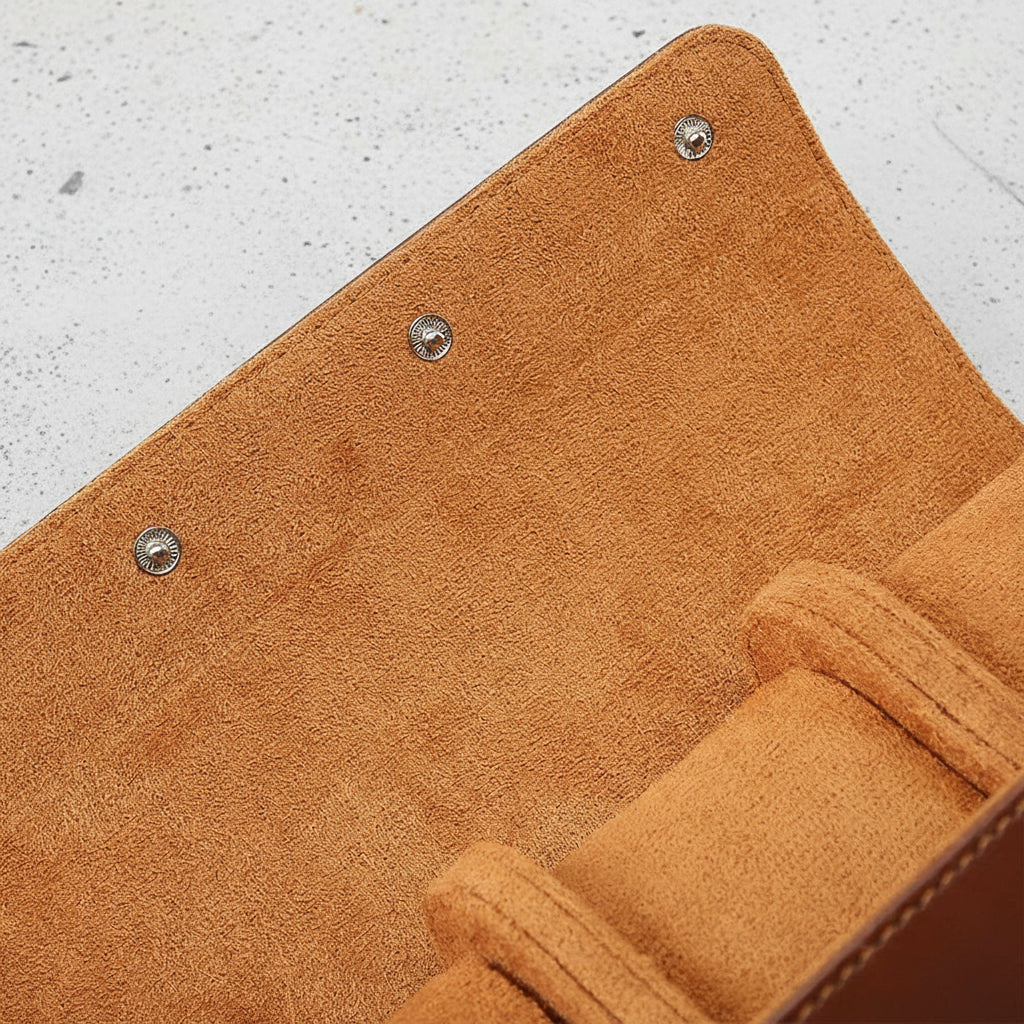 Close up of brown 3 watch roll, featuring soft light brown interior