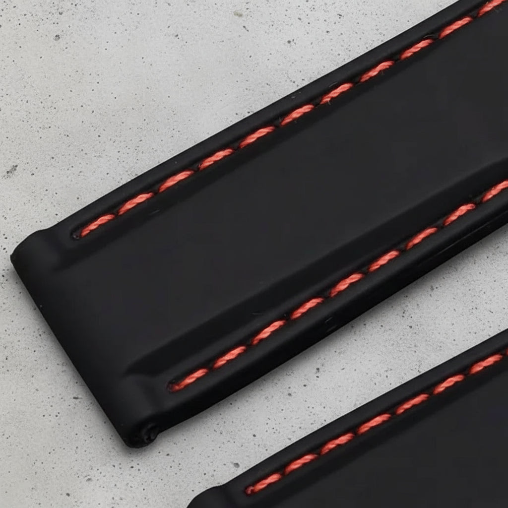 Black rubber strap with red stitching 
