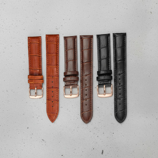 Set of three leather watch straps in brown, dark brown, and black with rose gold buckles 