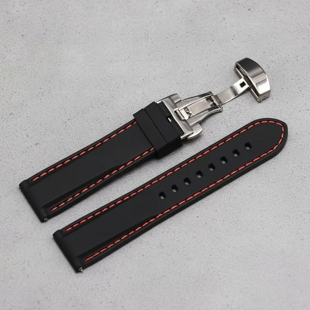 Black watch strap with red stitching and silver butterfly clasp