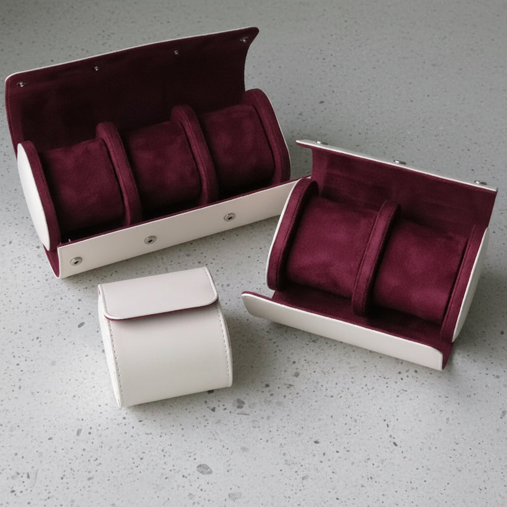 Three white leather and maroon watch cases 