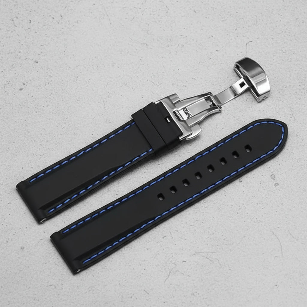 Black watch strap with blue stitching and silver butterfly clasp